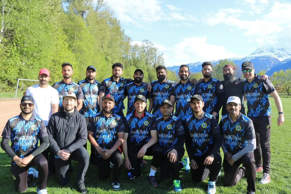 The Revelstoke Cricket Club squad in club colours, mountains behind them